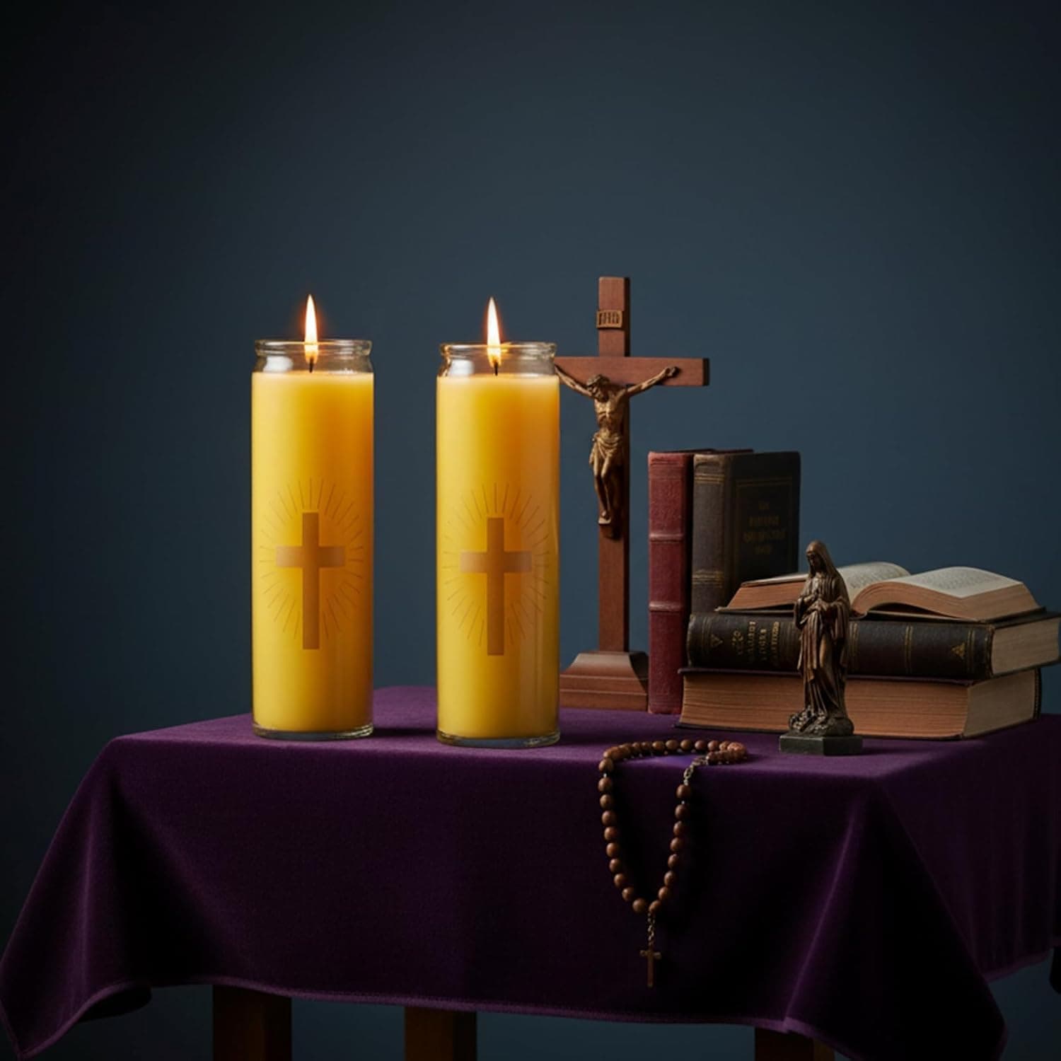 A lit Anovia 7-day beeswax devotional candle with a gold cross on a prayer table
